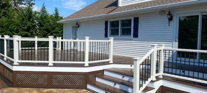 Washed composite deck with metal railing and wood railing post.